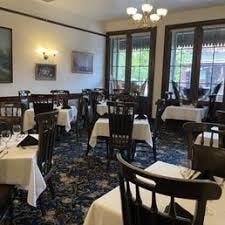 The Dining Room interior with white tablecloths and Victorian decor
