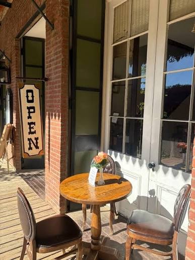 Outdoor patio dining with OPEN sign at Columbia City Hotel