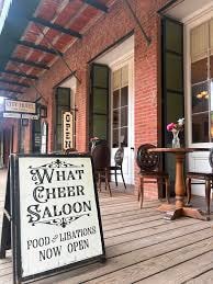What Cheer Saloon Food and Libations sign on the porch
